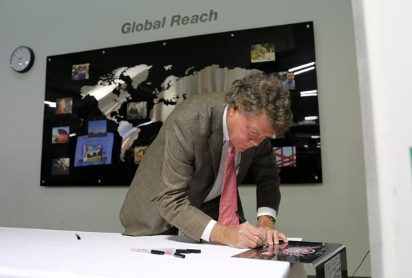 Hypertherm Founder Dick Couch putting his signature on the 100,000th Powermax45 system